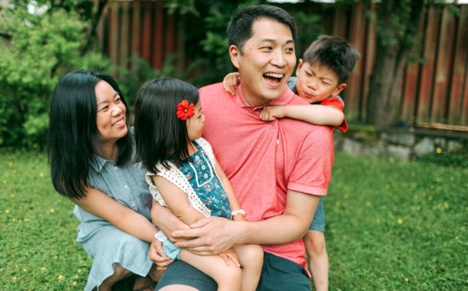 A happy family laughing together on the lawn